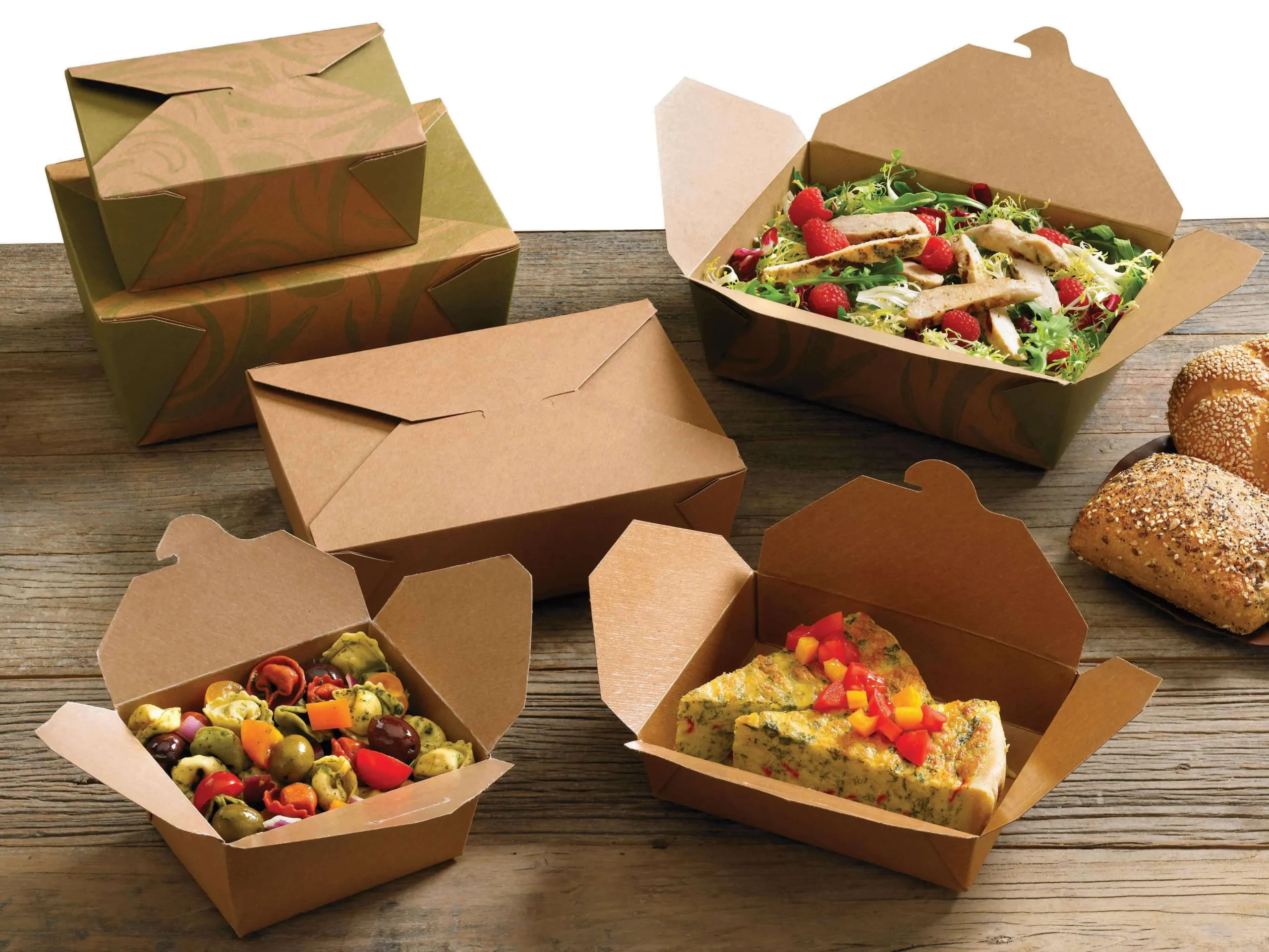 A table covered with an array of food items in cardboard boxes, emphasizing the practicality of food packaging options.